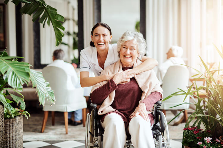 senior in wheelchair with caregiver