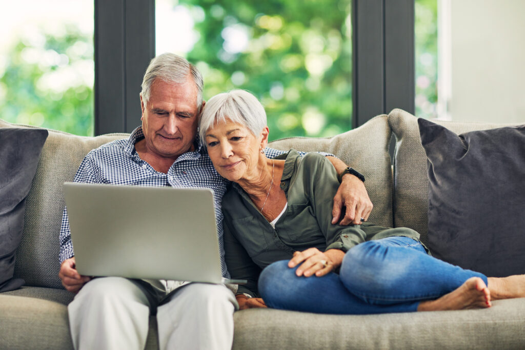 Shot of a senior couple using a laptop on the sofa at home