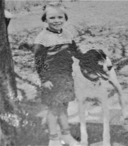 old, black and white photo of a young girl and her dog