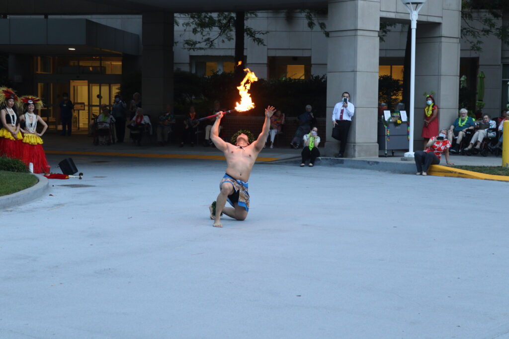 a man performs a traditional Polynesian fire dance