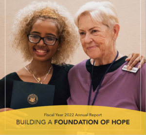 younger woman places arm around older woman. building a foundation of hope annual report