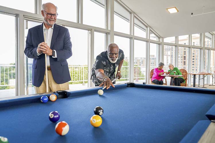 Older adults playing pool at TVA.