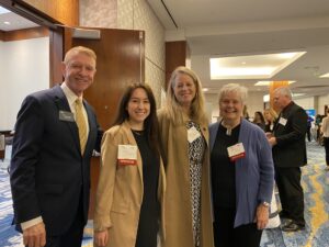 Alexandria Chamber CEO Joe Haggerty with Goodwin Living team member Ioana Munteanu, and on the far right GHA resident Marilyn Gould