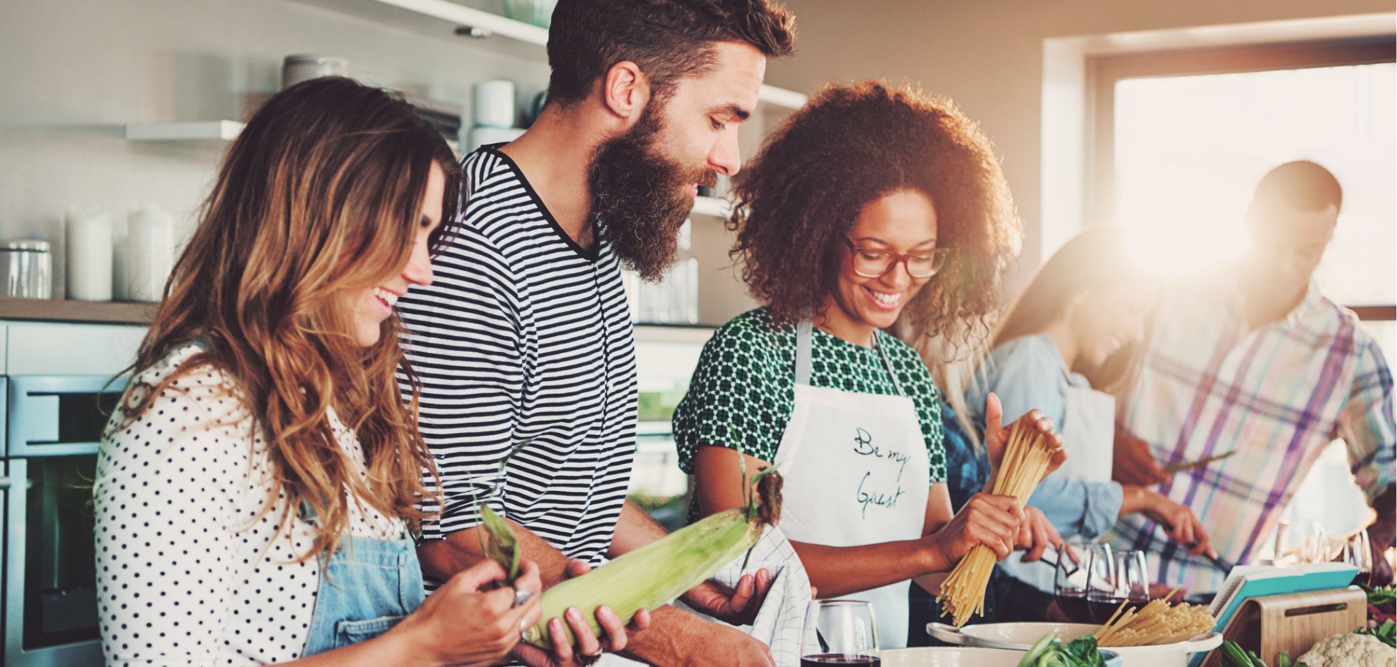 community of cooks. a group of young adults cook together.