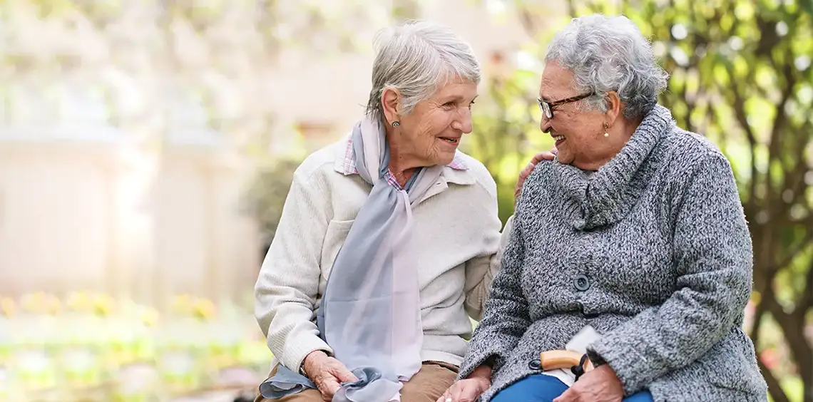 Two friends having a conversation outside