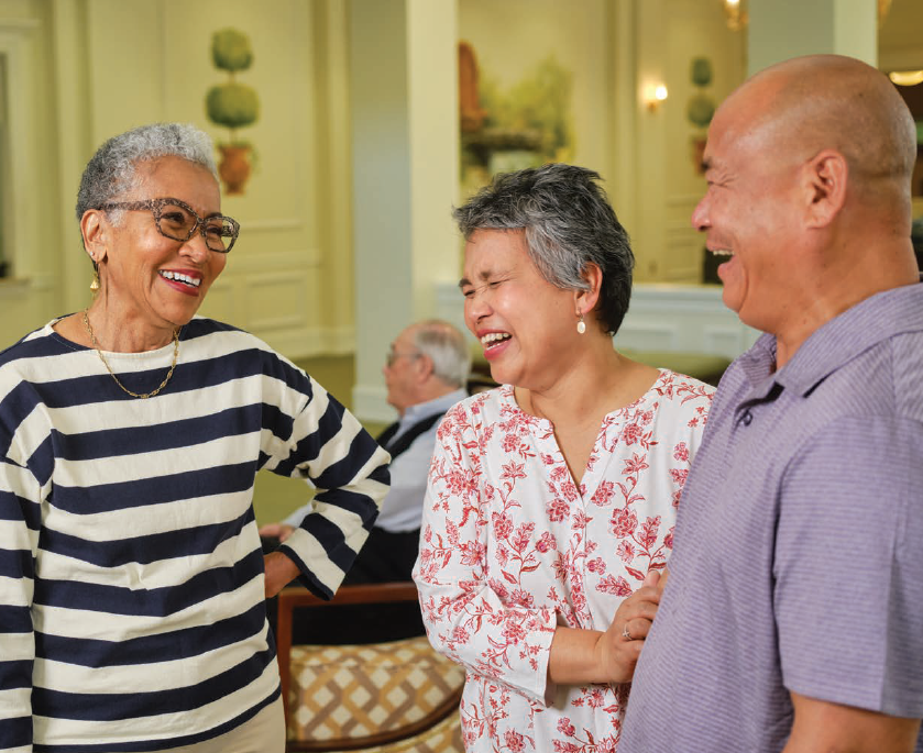 Older Adults enjoying a conversation in the lobby .